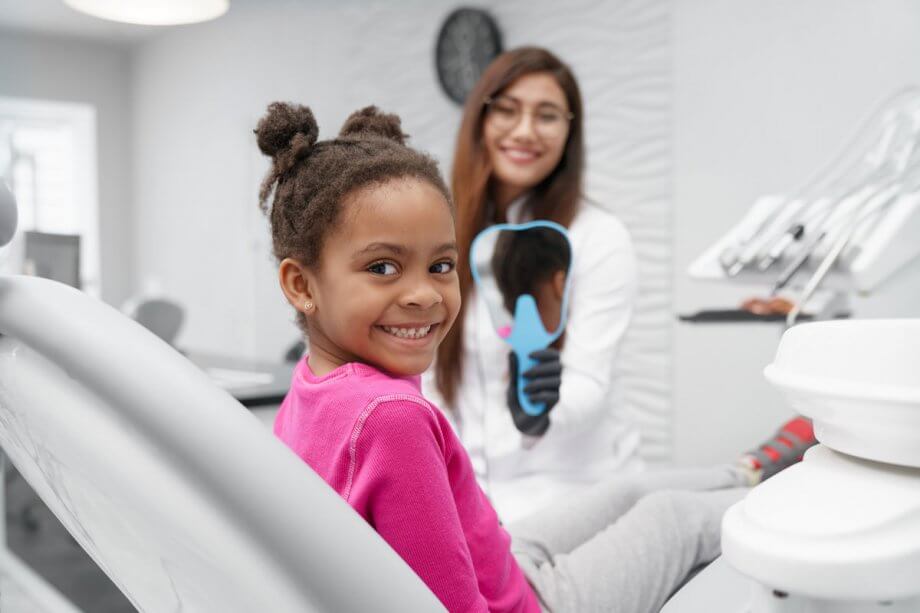 girl smiling in a dental chair