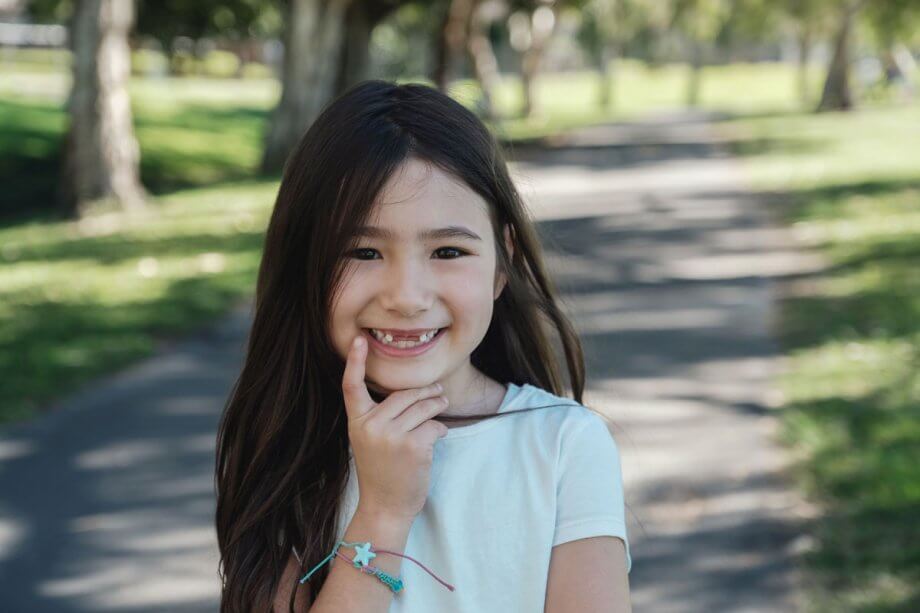 smiling girl with missing teeth