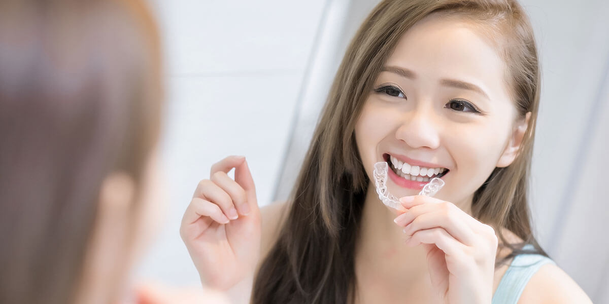 Young girl using clear aligner tray