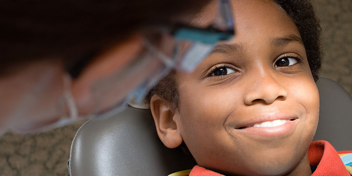 Young child smiling in dental chair